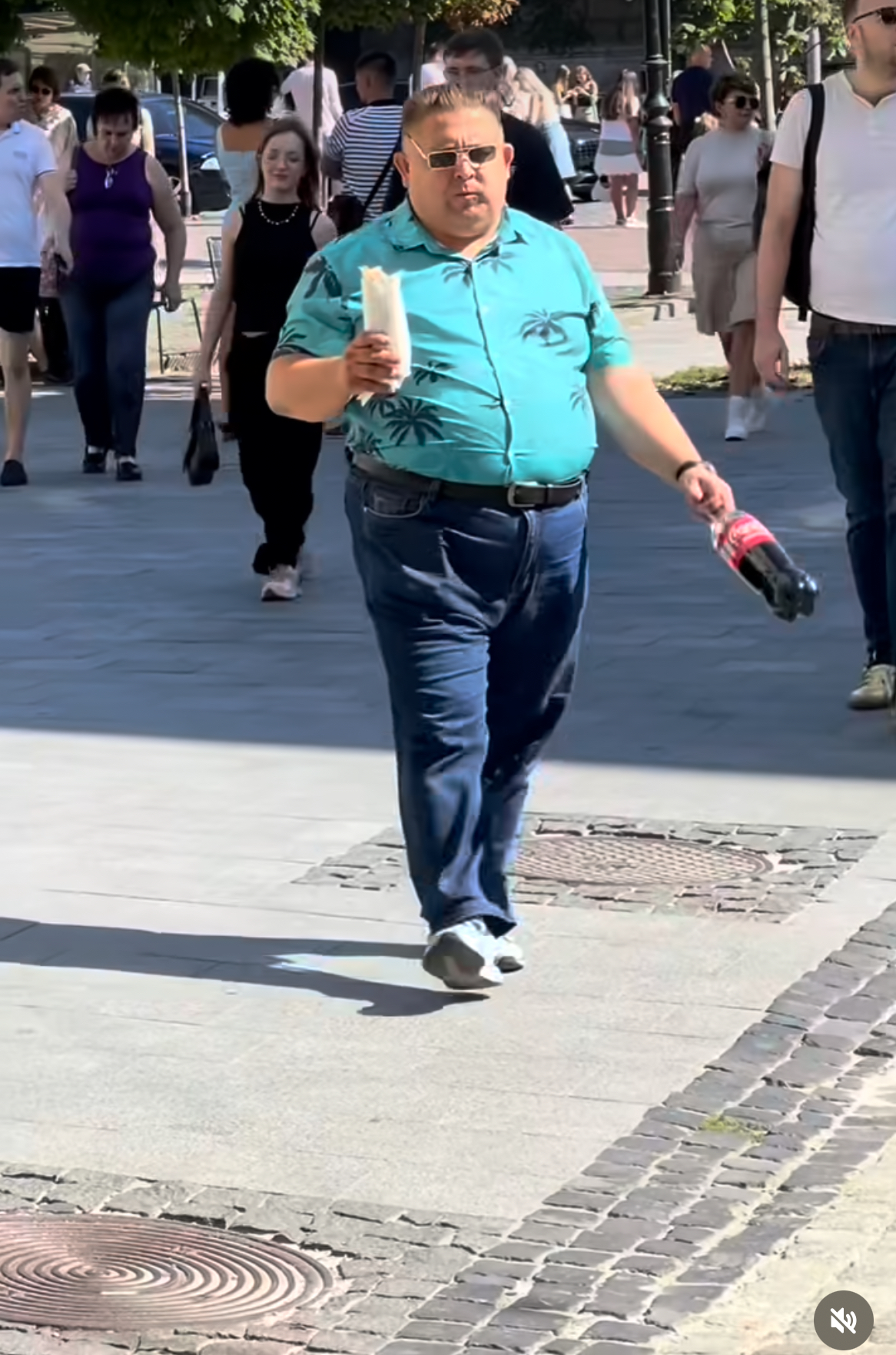 Slava Pomidor walking through a European street at dusk